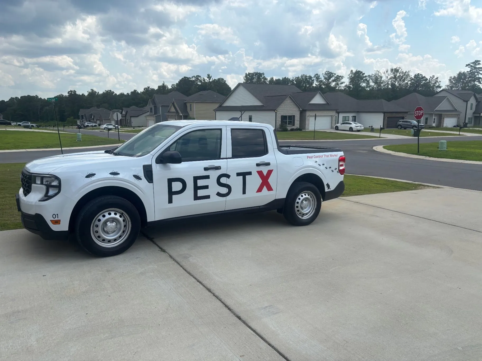 Pest X service truck parked in a residential neighborhood in Jasper, Alabama.