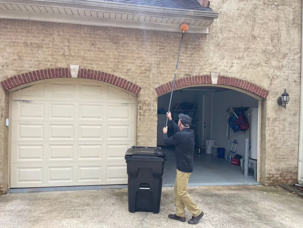 Scott Gilbert removing webbing from a Dora, Alabama home.